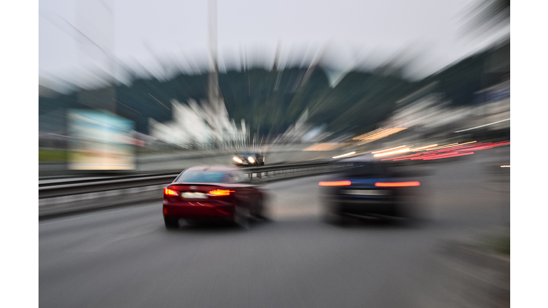 Evening city street racing cars blurred motion