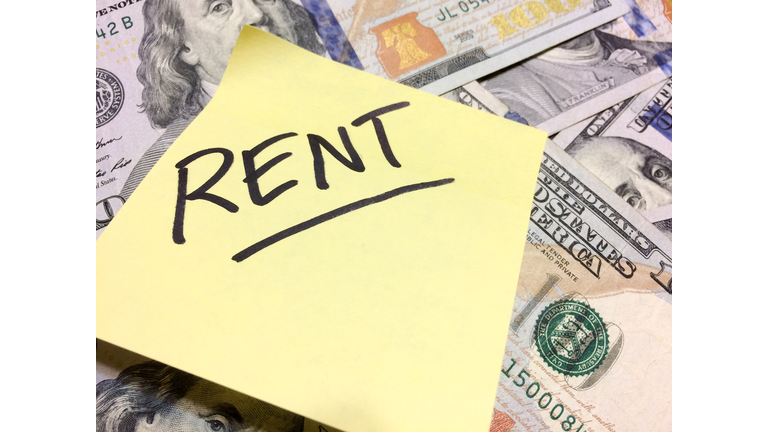 American cash money and yellow post it note with text Rent