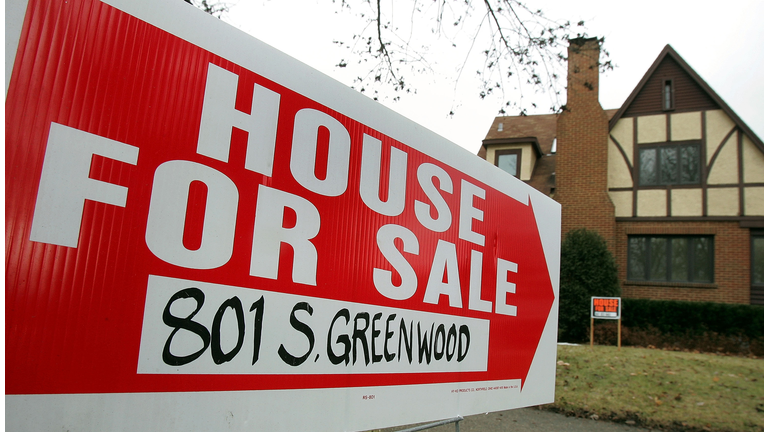 A home with a "for sale" sign. 