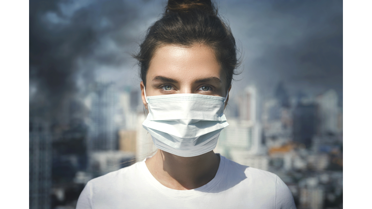Woman wearing face mask because of air pollution in the city