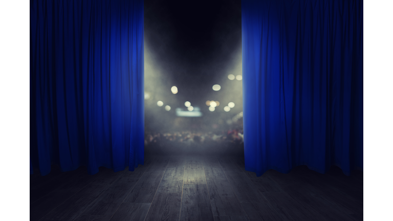 The blue curtains are opening for the theater show