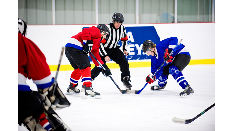 Men playing ice hockey