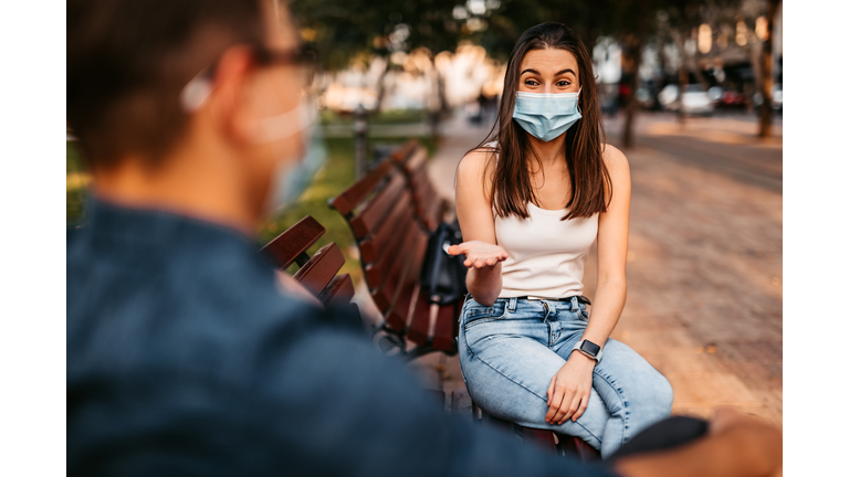 Young couple making social distance on date