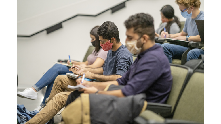 College Students wearing masks in a lecture hall