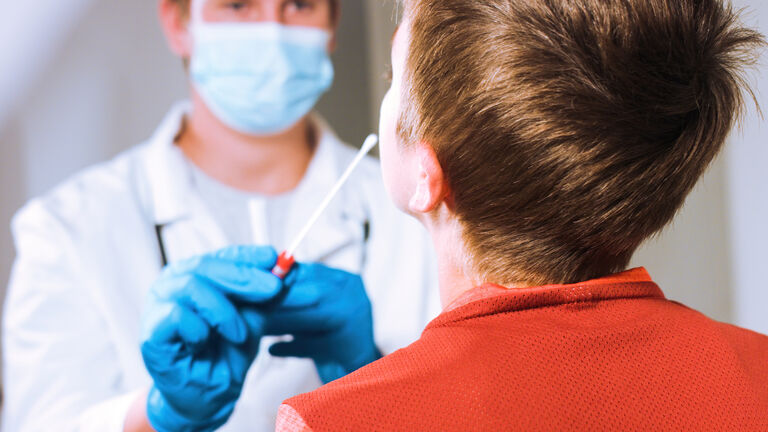 Doctor testing child for coronavirus