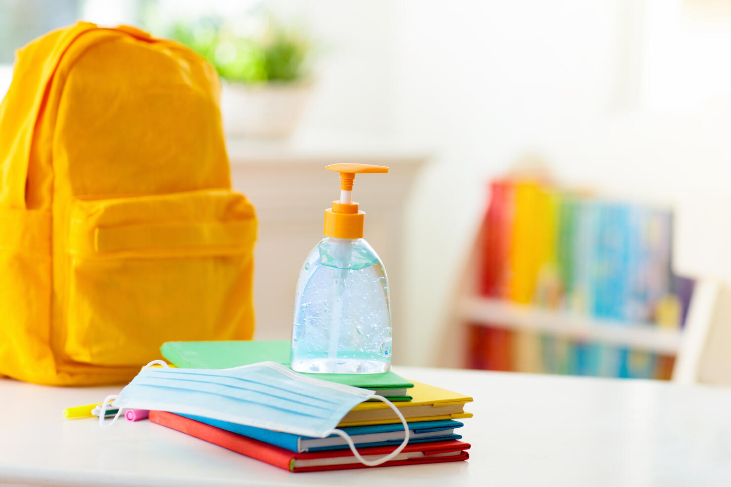 Backpack of school child. Face mask and sanitizer.