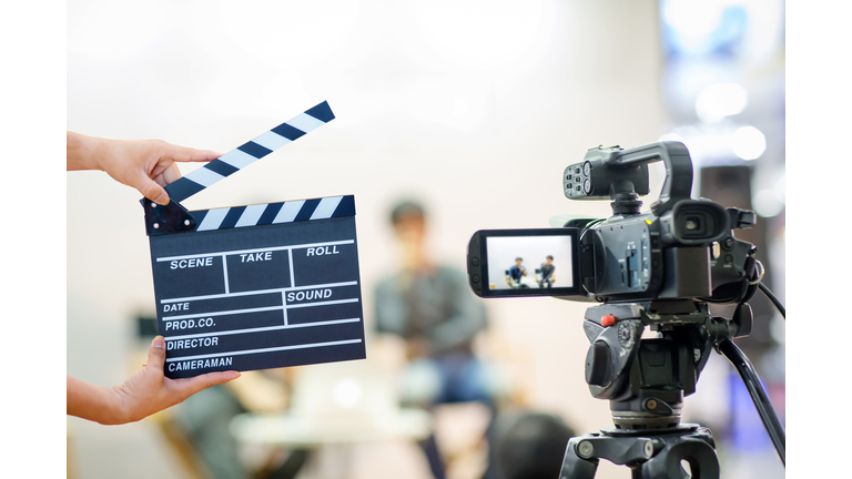 Man hands holding movie clapper.