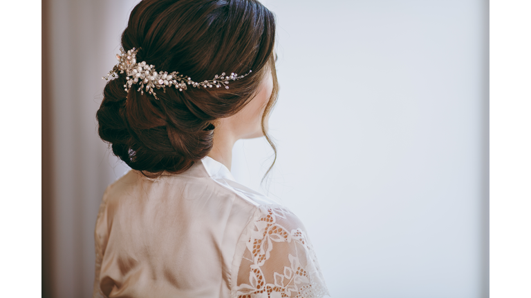 Beautiful bride doing a hairstyle in the morning