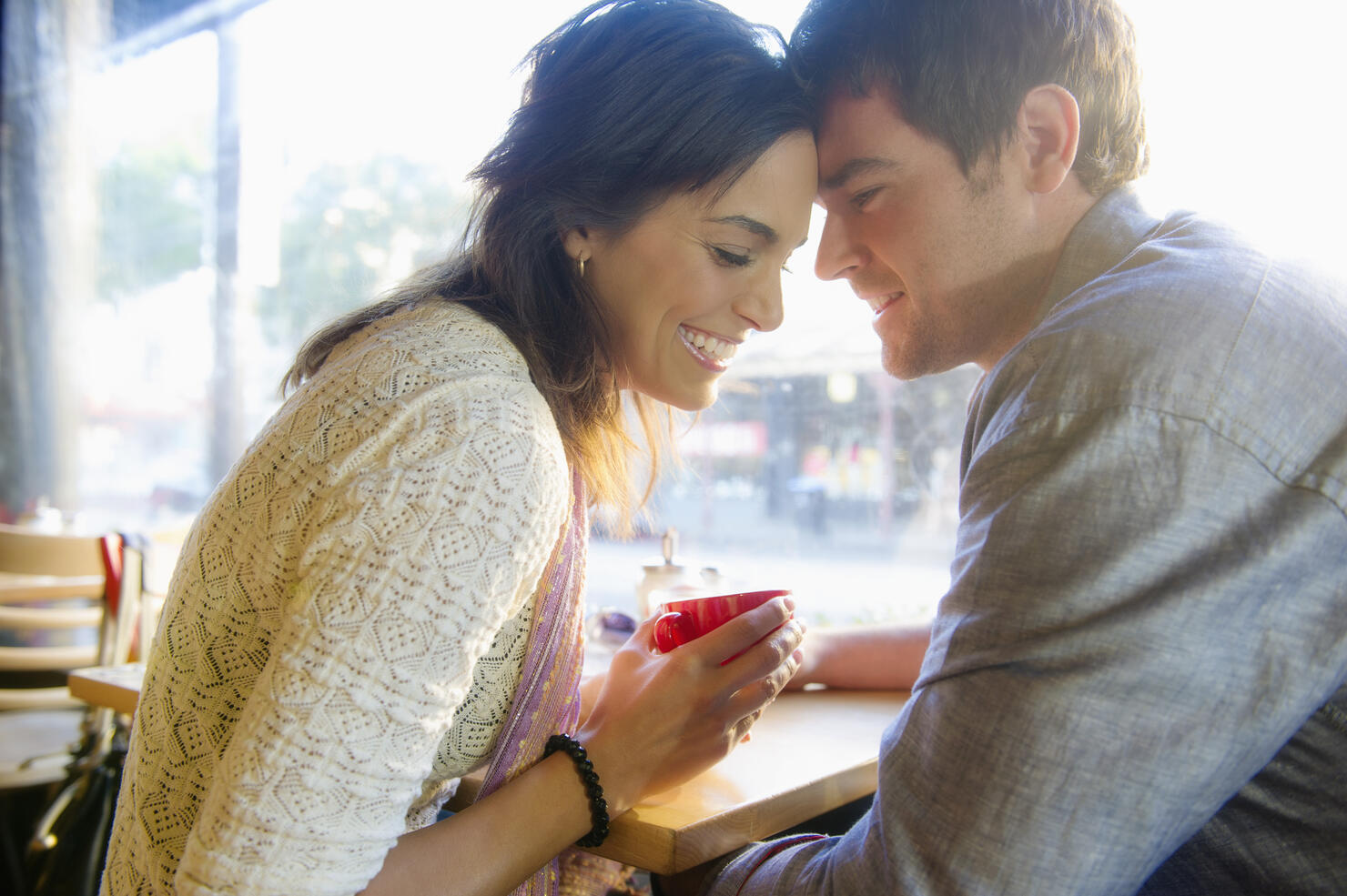 Couple holding hands in cafe