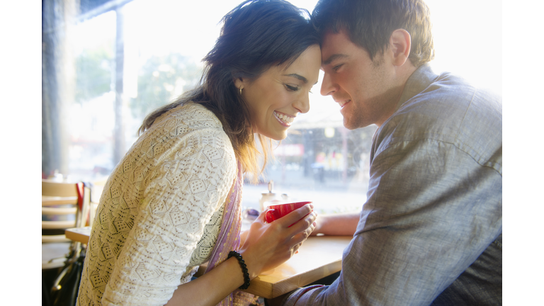 Couple holding hands in cafe