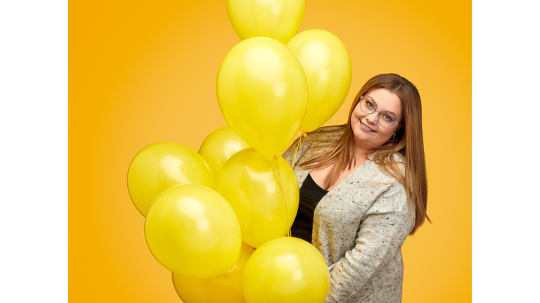 Smiling plump lady with balloons