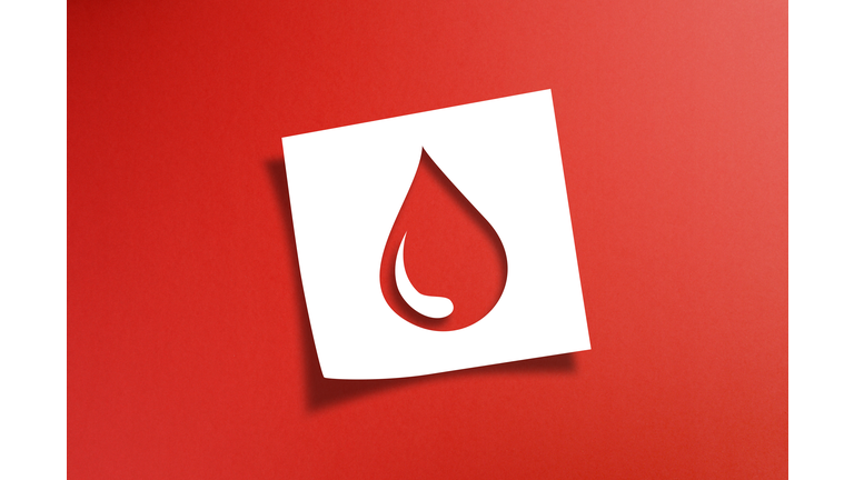 Note paper with blood donation concept on red background