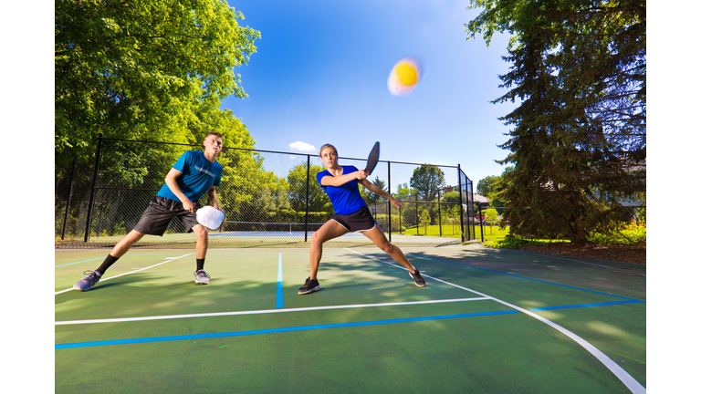 Young Man and Woman Pickleball Player Playing Pickleball in Court