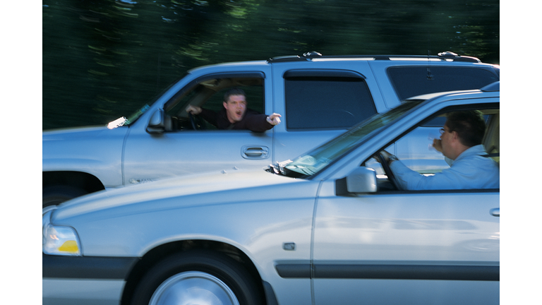 Men arguing with each other from their vehicles while driving