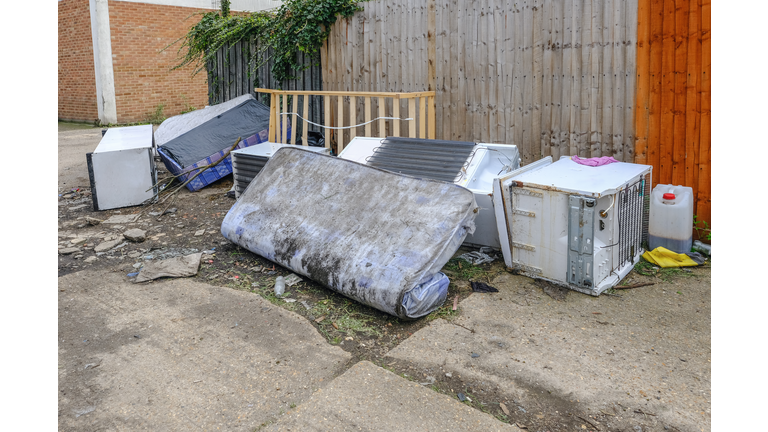 Large kitchen items dumped in an alleyway.