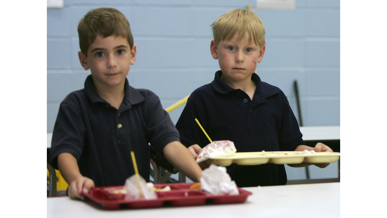 Two boys pick up their lunch trays at No