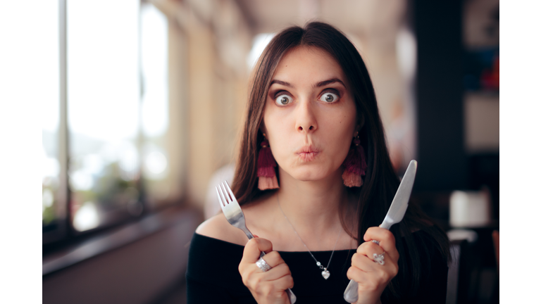 Hungry Woman with Knife and Fork Ready to Eat