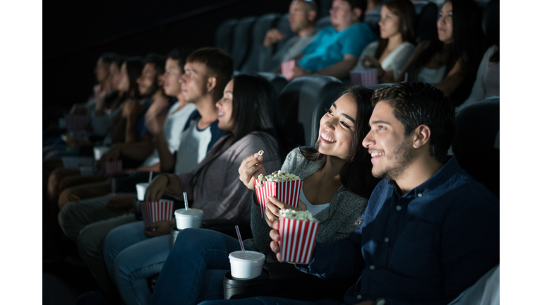 Happy Latin American couple at the movies