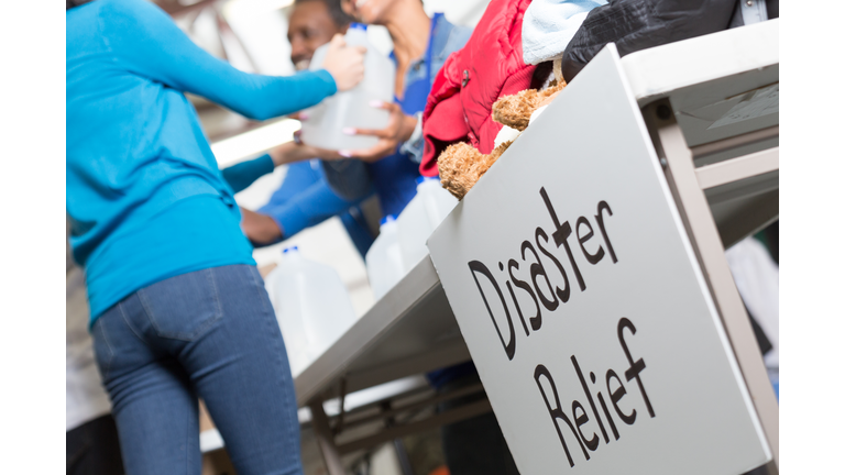 Closeup of Disaster Relief sign at center handing out water