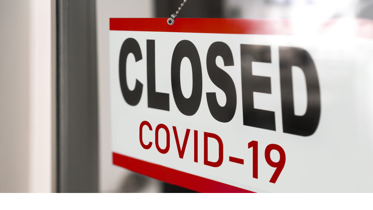 Closed businesses for COVID-19 pandemic outbreak, closure sign on retail store window banner background. Government shutdown of restaurants, shopping stores, non essential services