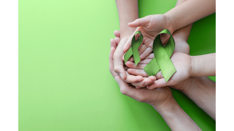 Adult and child hands holding Lime Green Ribbon