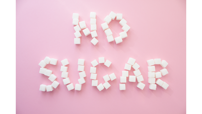 Directly Above Shot Of No Sugar Text Made With Food Over Pink Background