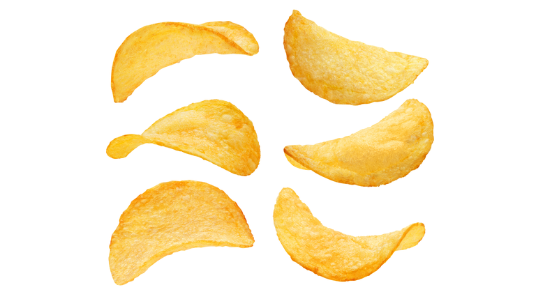 Set of delicious potato chips on white