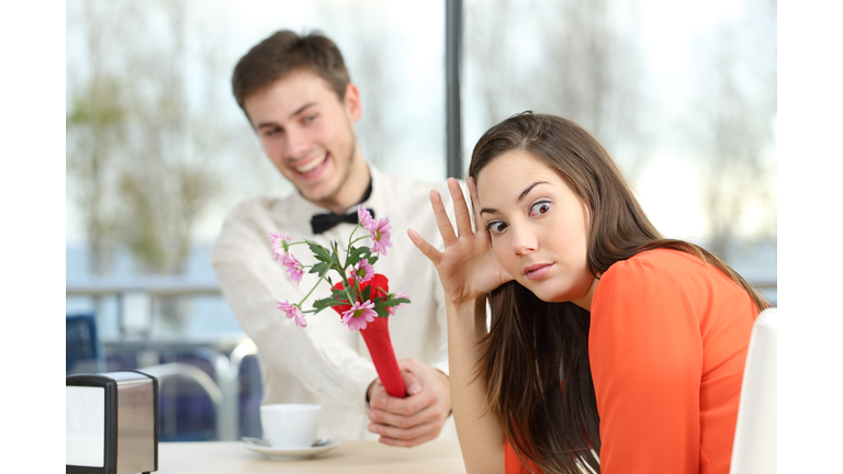 Woman rejecting a geek boy in a blind date