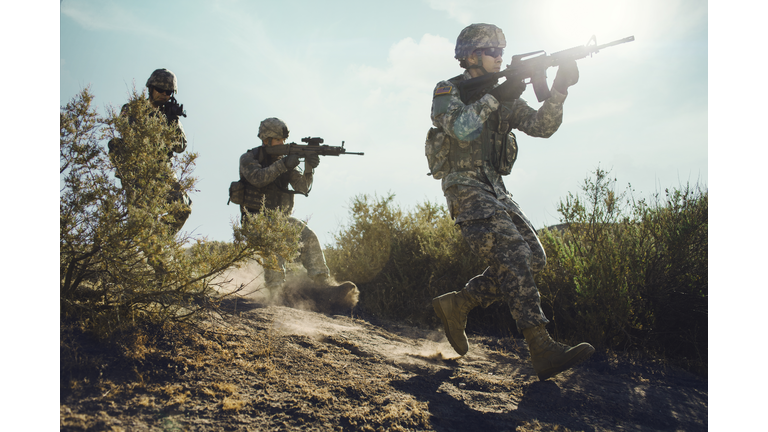Army soldiers advancing in combat.