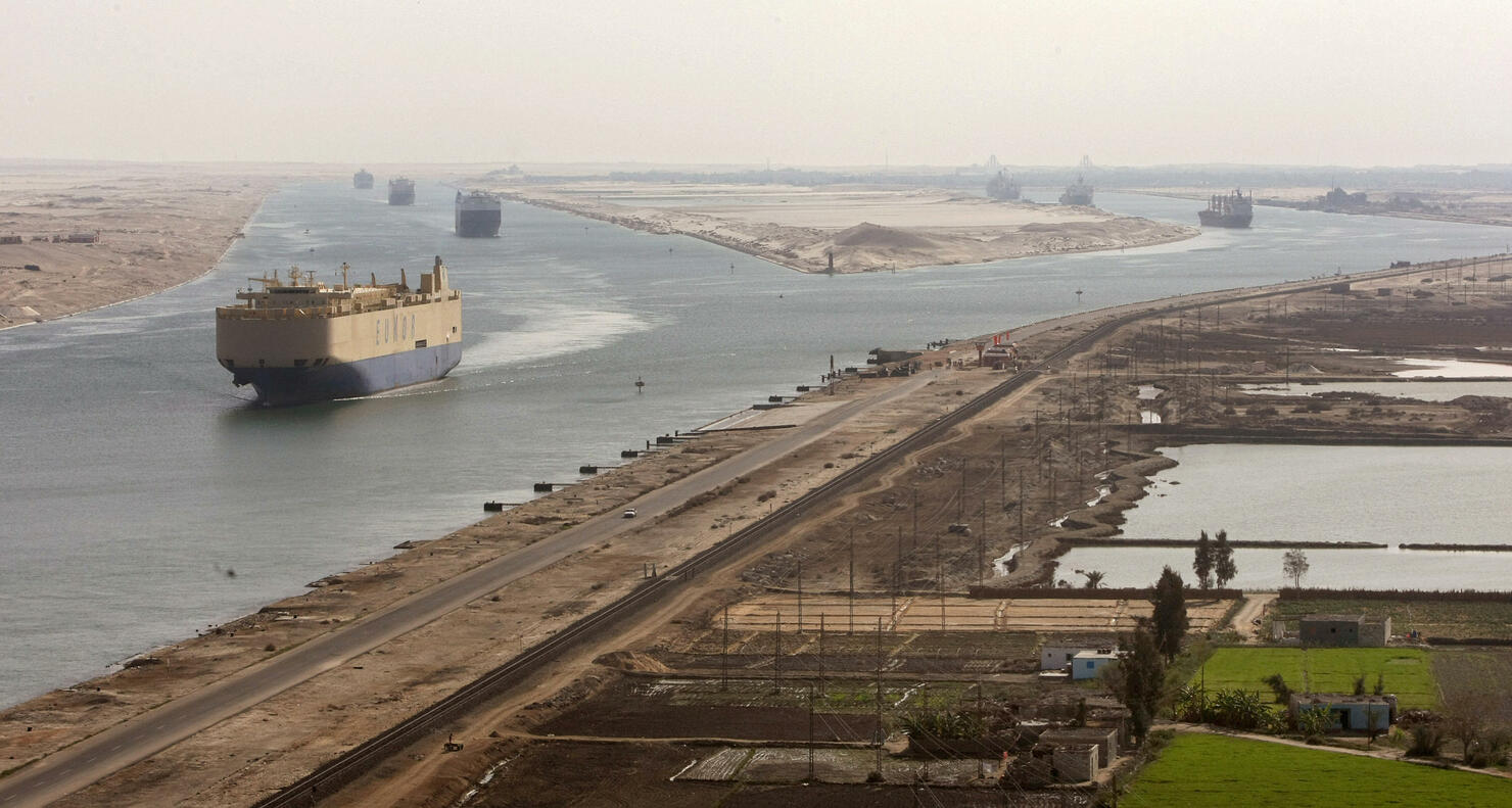 Cargo ships navigate in the Suez Canal b