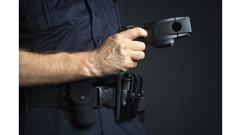 Police officer holding stun gun