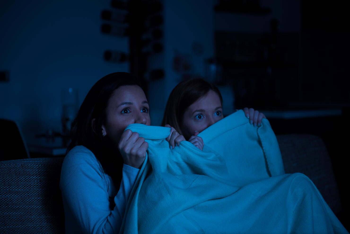Two women watching tv together, horror movie