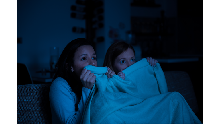 Two women watching tv together, horror movie