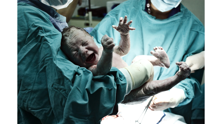 Doctor holding new born