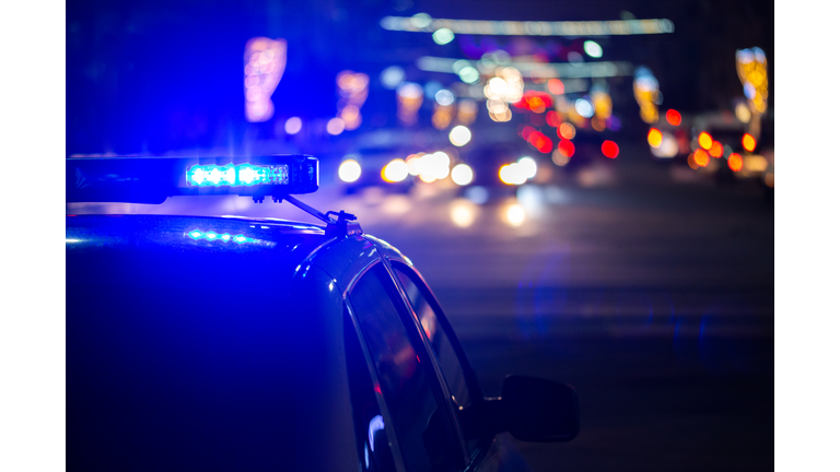 police car lights at night in city with selective focus and bokeh