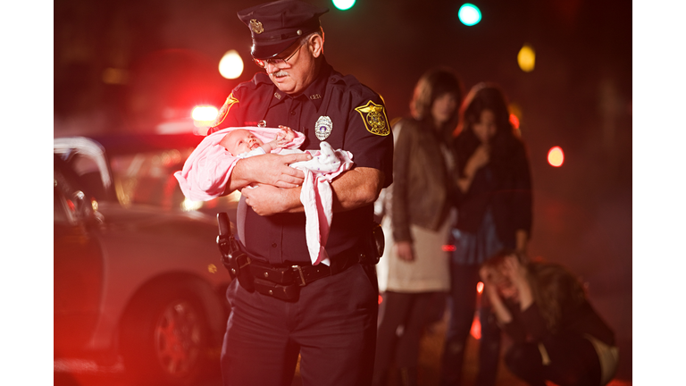 Police officer rescuing a baby