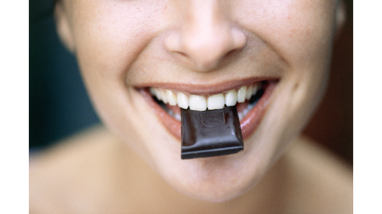 Young Woman Eating Chocolate
