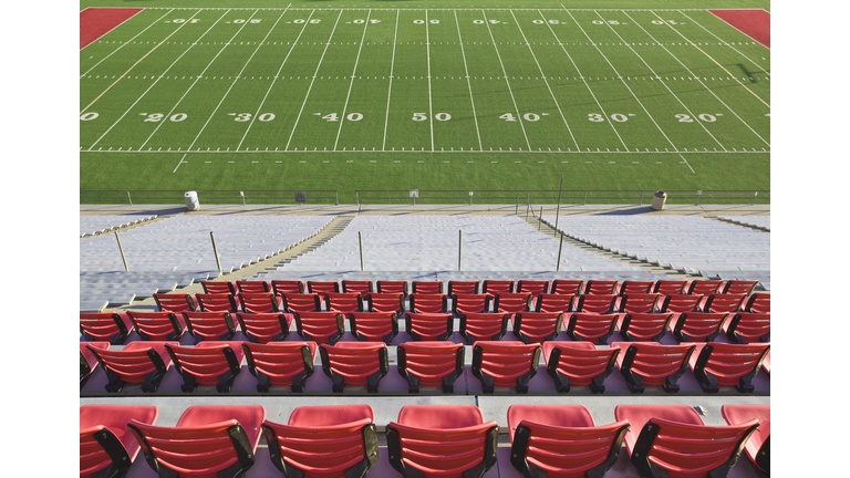 Empty football field and stadium seats.