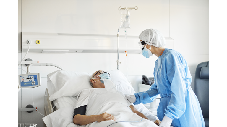 Doctor consoling patient in ICU during COVID-19