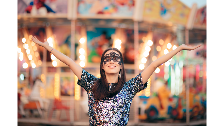 Woman Wearing carnival Mask at Funfair Amusement Park