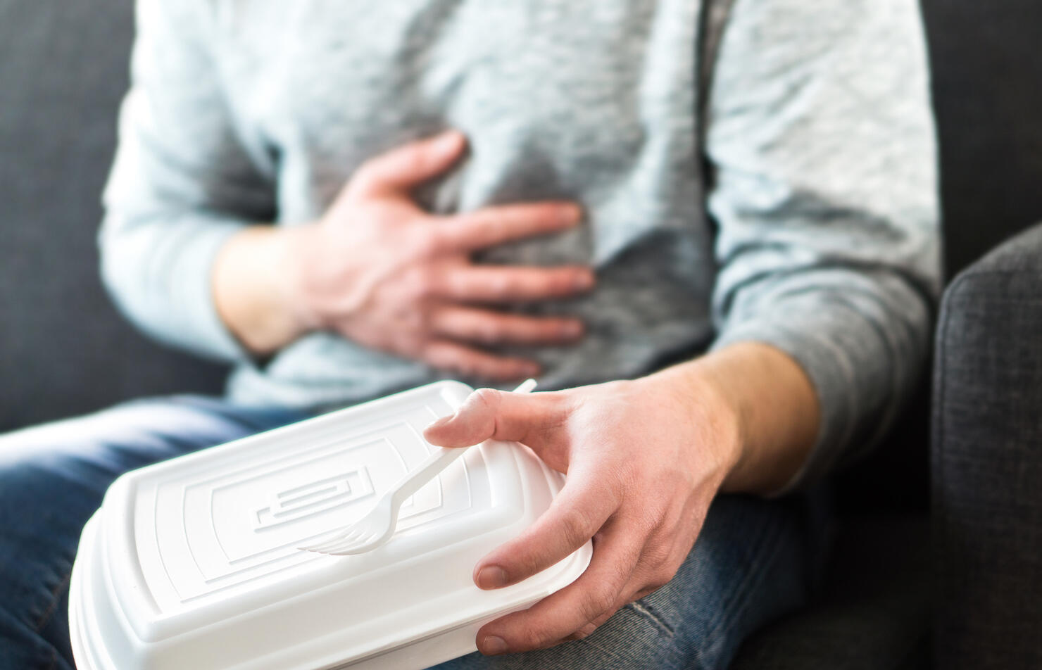 Man having diarrhea or food poisoning after unhealthy junk fast food. Guy has to go to toilet after eating too much.