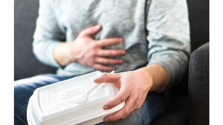 Man having diarrhea or food poisoning after unhealthy junk fast food. Guy has to go to toilet after eating too much.