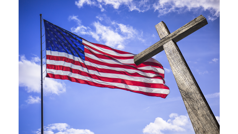 American flag with a wooden cross