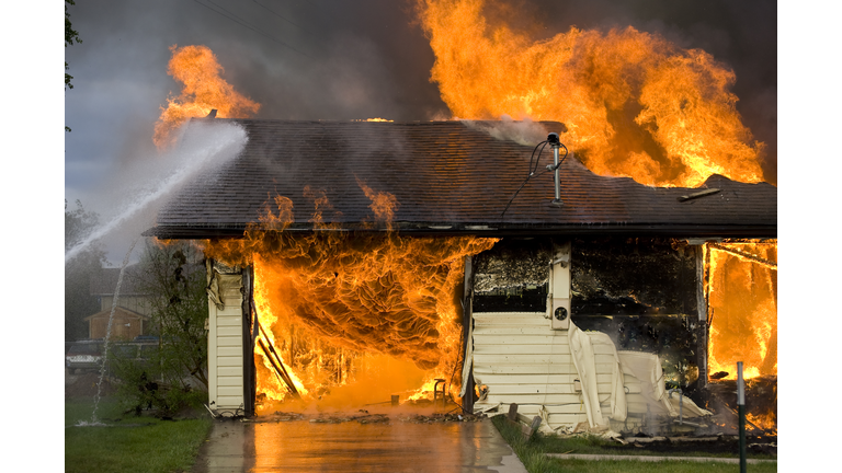Firemen Putting Out a House Fire Disaster