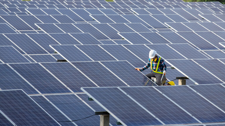 Asian engineer working on checking equipment in solar power plant, Pure energy, Renewable energy