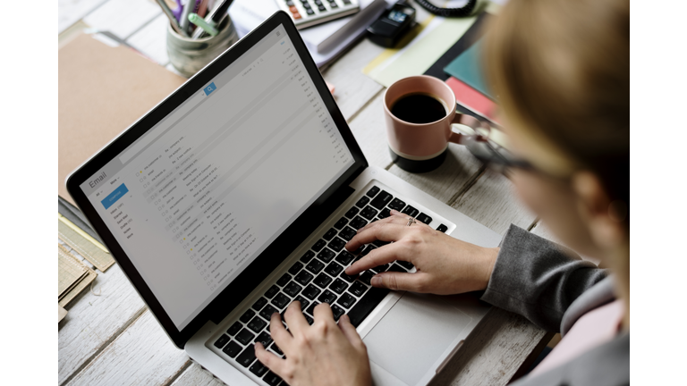 Businesswoman Checking E-mail Online on Laptop