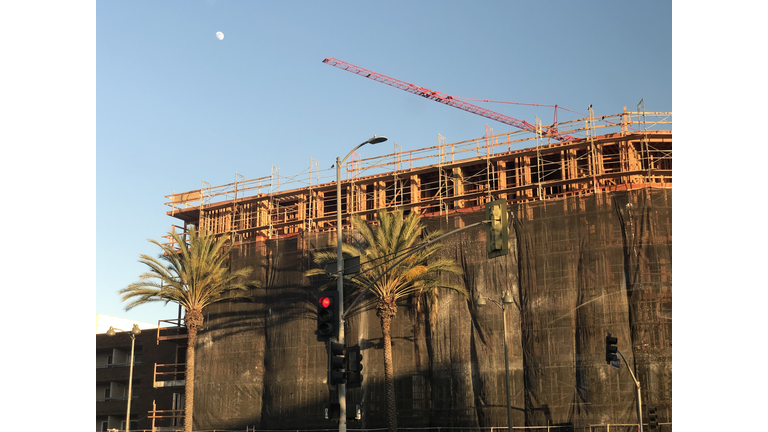 Low Angle View Of Crane By Building Against Clear Sky