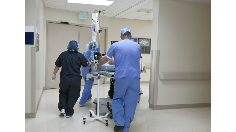 Patient being rushed through hospital corridor