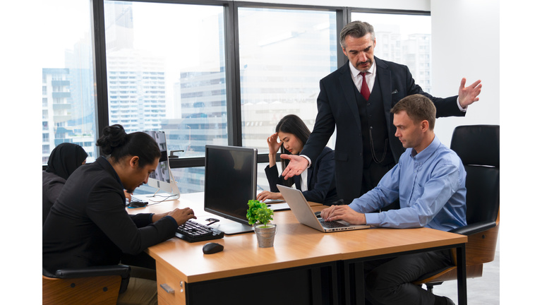 The frustrated CEO is angry with his co-worker during an office meeting.