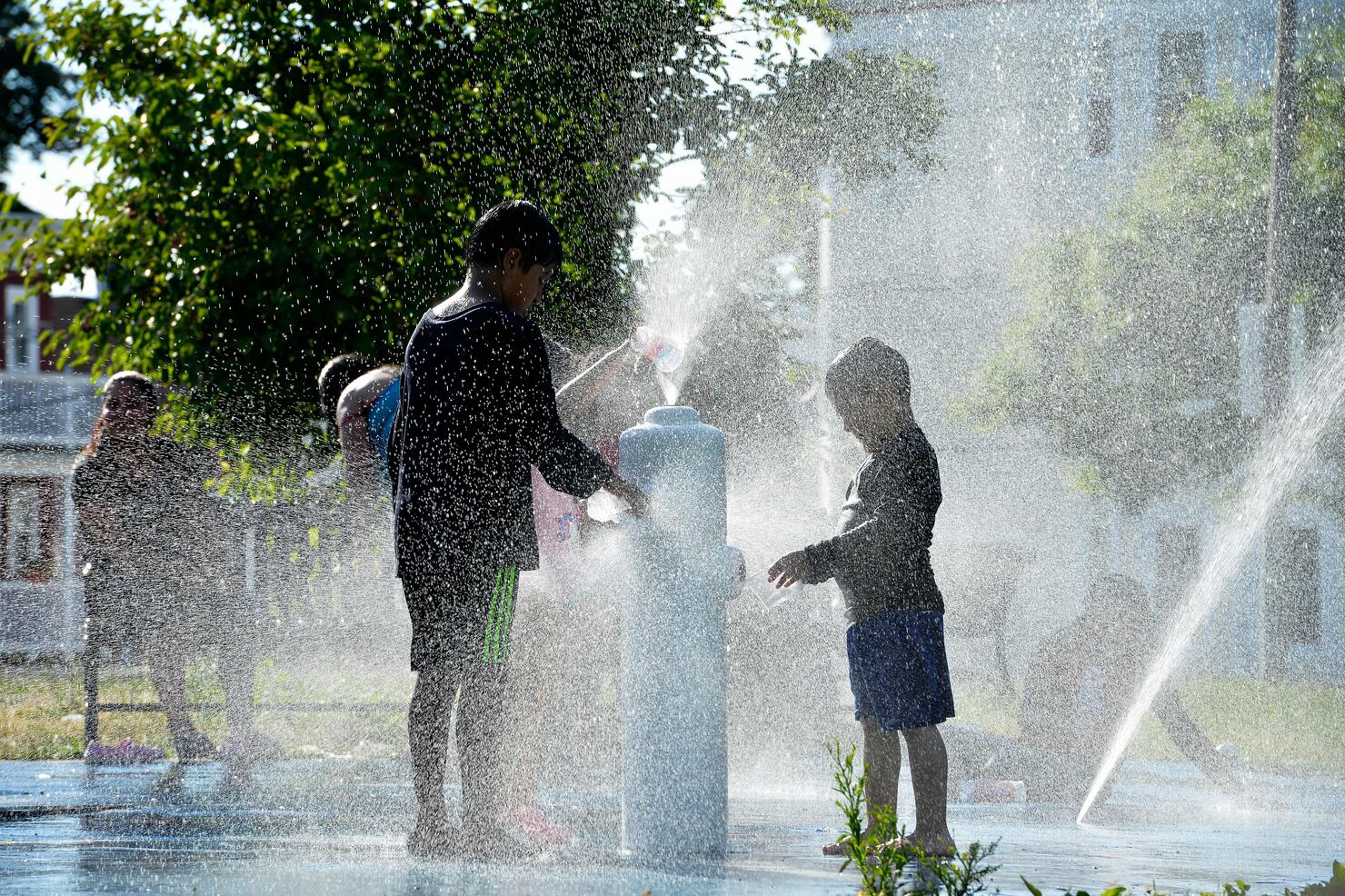 Children play at a splash pad 